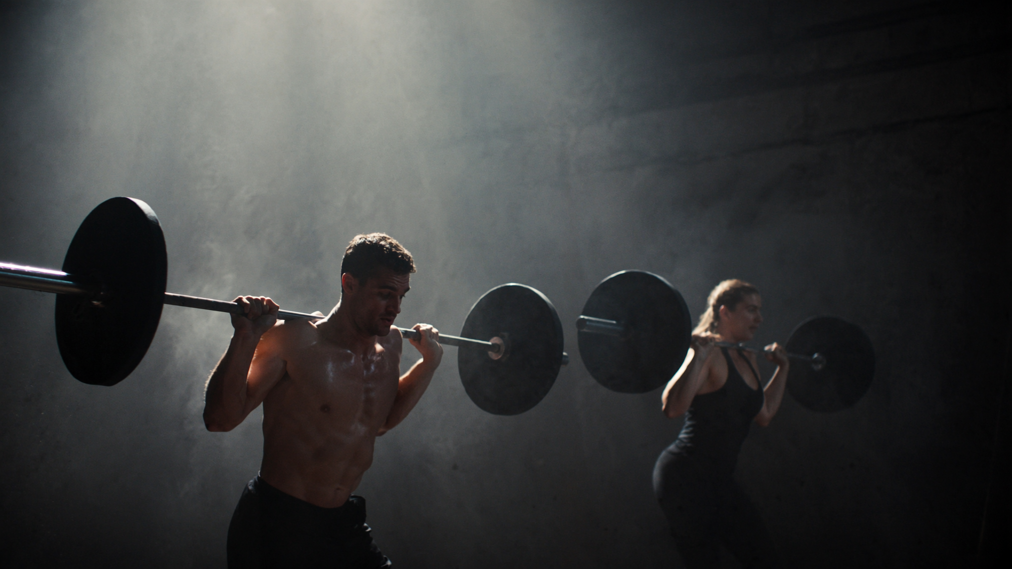 Athletes back squatting